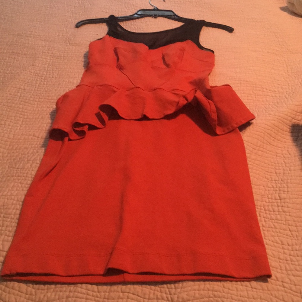 A orange dress fitting dress too and clear top .